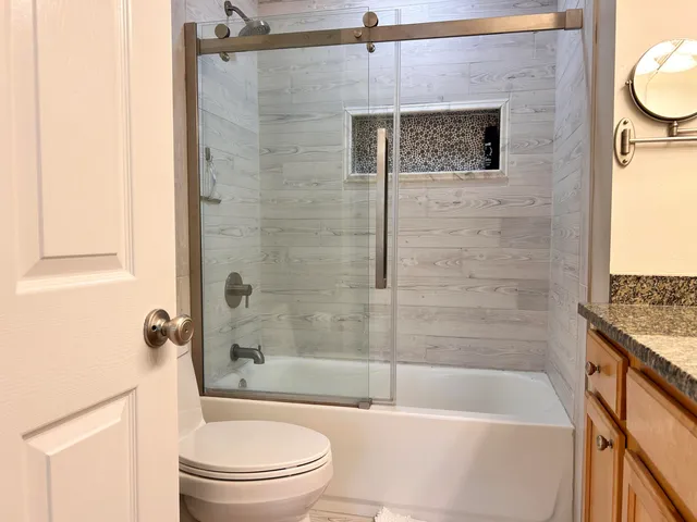 a bathroom with a shower and a tub