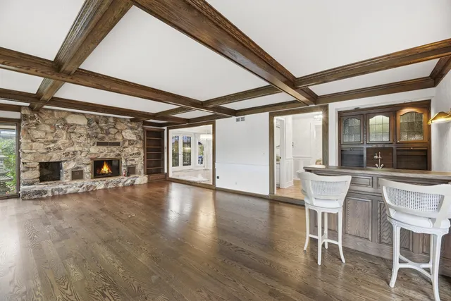 a view of a livingroom with furniture wooden floor and a fireplace
