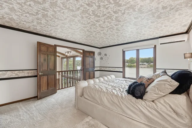 a bed sitting in a bedroom next to a balcony