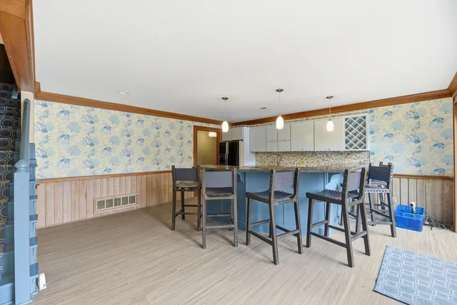 a dining room with a wooden table and chairs