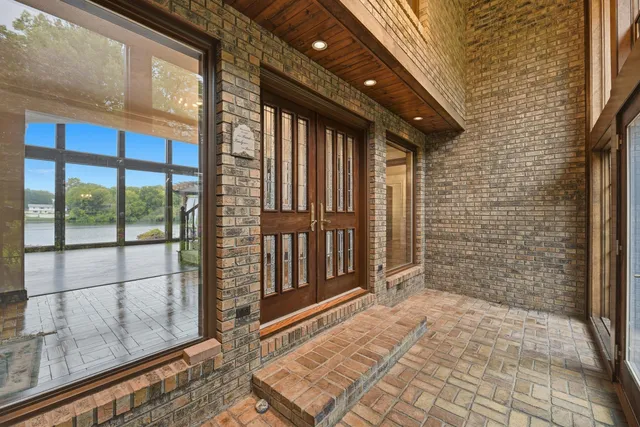 a view of a brick house with a large window