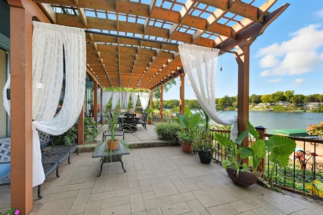 a view of a patio with chairs and potted plants