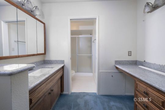 736 Sherri Street Ridgecrest, CA 93555 - Photo 12 of 42 a bathroom with a granite countertop sink and a mirror
