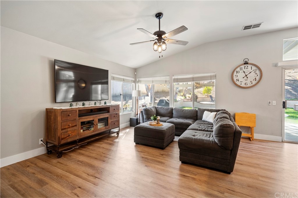 22877 Mountain Ash Circle Corona, CA 92883 - Photo 6 of 41 a living room with furniture and a flat screen tv
