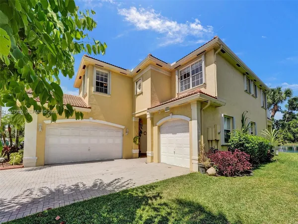 a front view of a house with a yard and garage