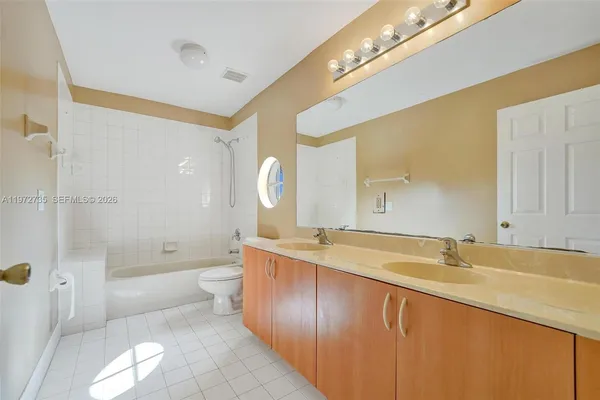 a view of a house with a yard and potted plants