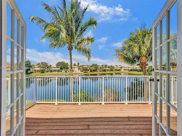 a view of a house with backyard porch and sitting area