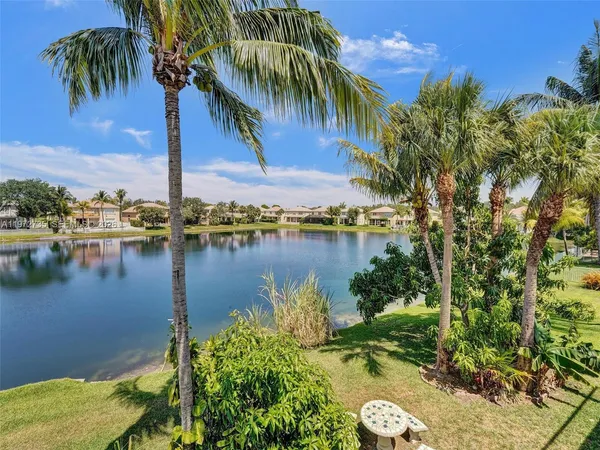 a view of swimming pool with a garden and trees