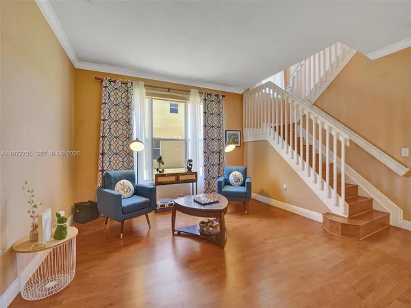 a view of dining room with furniture window and wooden floor