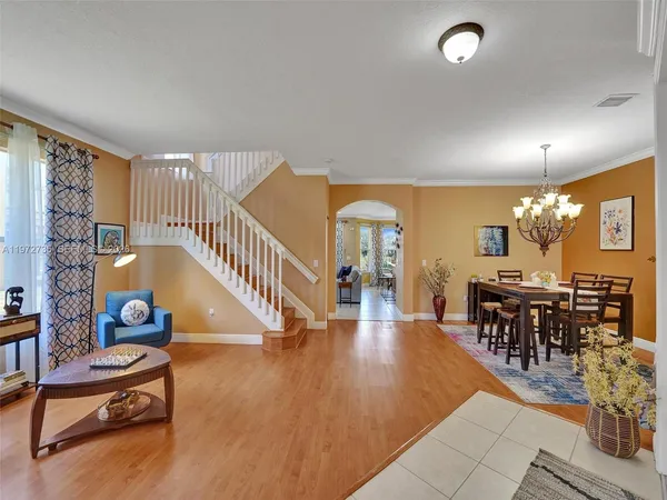 a living room with furniture and wooden floor