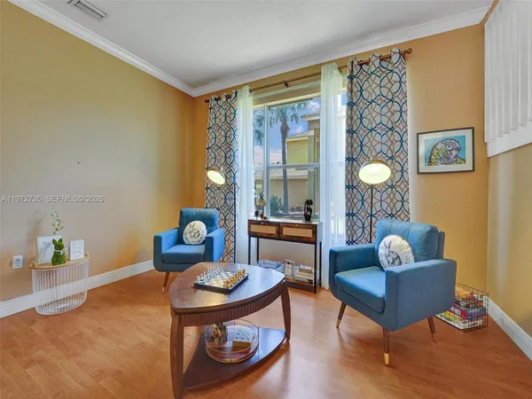 a view of a livingroom with furniture window and wooden floor