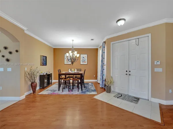 a dining room with furniture and window