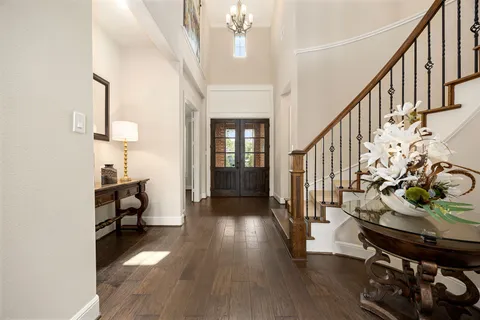 a view of entryway and hall with wooden floor