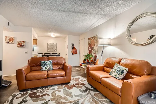 a bed room with a bed a flat screen tv and a couch