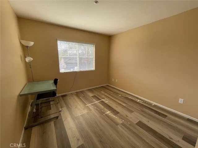 a view of a room with wooden floor and bathroom