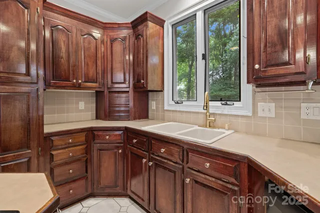 a kitchen with a sink and large window