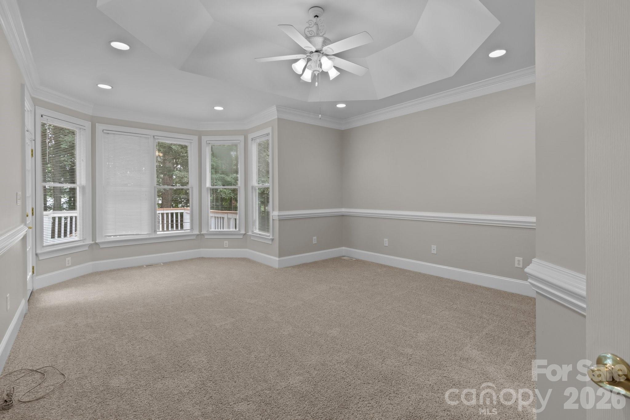 165 Futrell Landing New London, NC 28127 - Photo 22 of 48 an empty room with windows and ceiling fan