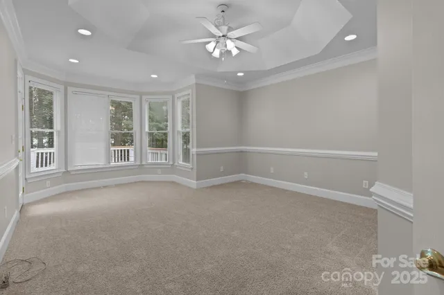 wooden floor in an empty room with a ceiling fan