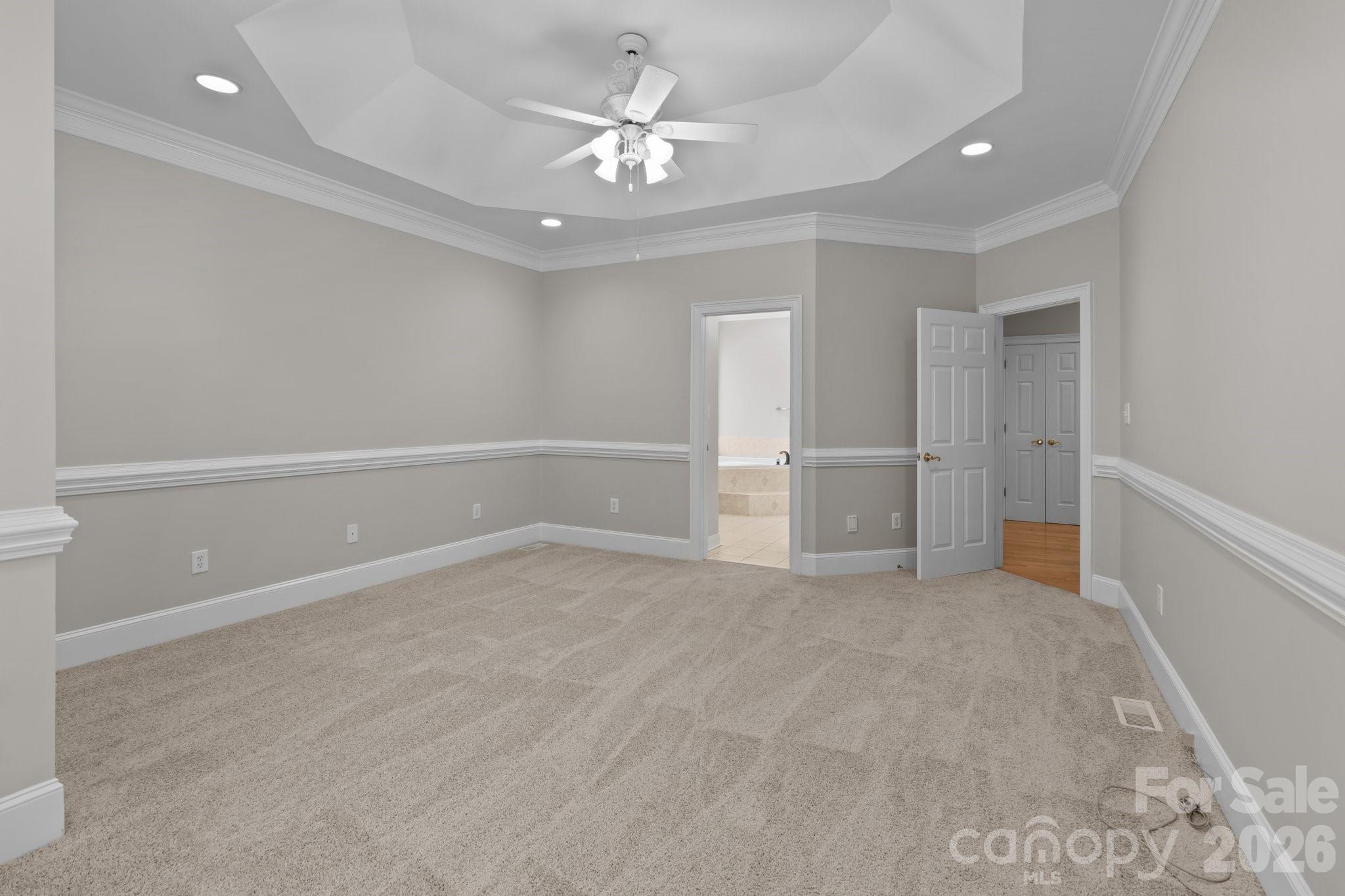 165 Futrell Landing New London, NC 28127 - Photo 23 of 48 wooden floor in an empty room with a ceiling fan