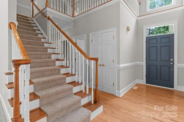 a view of entryway with wooden floor and stairs