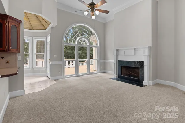 a view of livingroom with fireplace fan and a fireplace