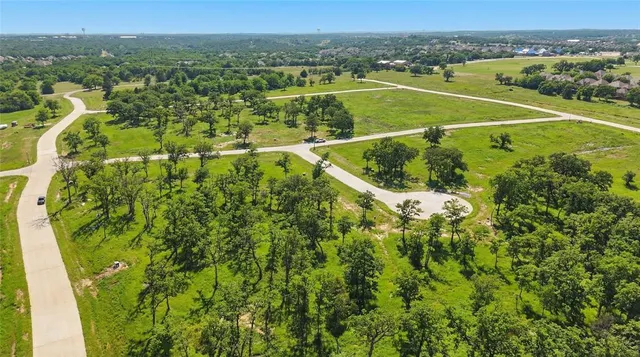 an aerial view of a golf course with a swimming pool