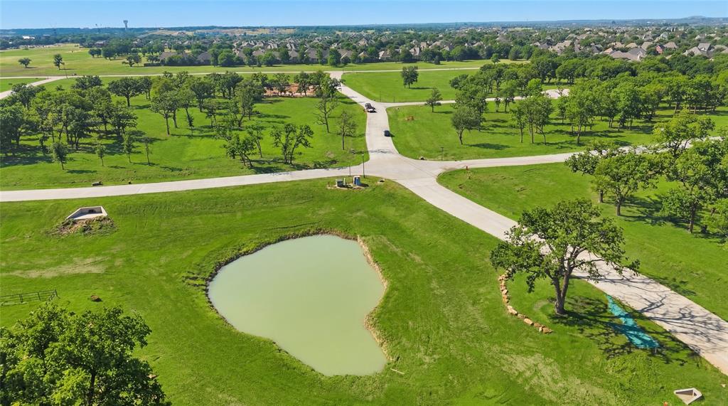 712 Sutton Lane Lewisville, TX 75077 - Photo 4 of 7 an aerial view of a golf course with a swimming pool