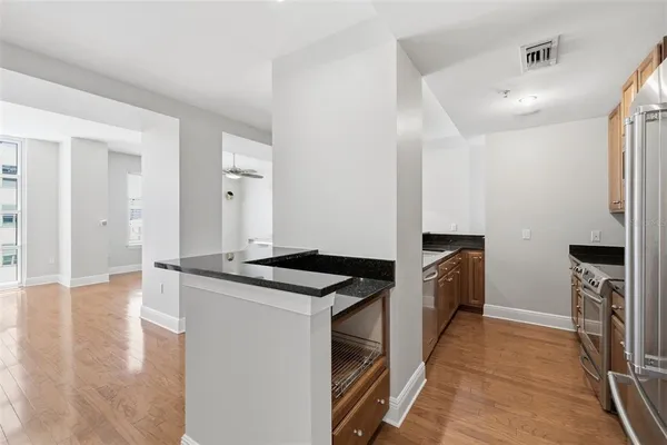 a kitchen with granite countertop a stove and a microwave