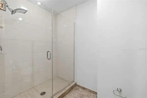 a bathroom with a sink a toilet a mirror and shower