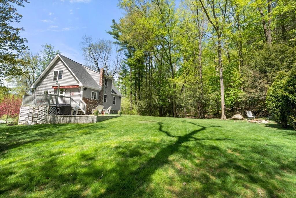 96 Sturbridge Road Holland, MA 01521 - Photo 4 of 25 a view of a house with a big yard and large trees