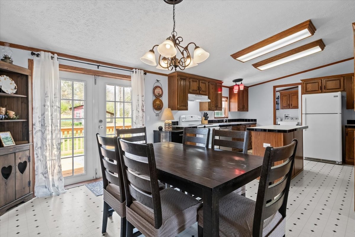 1644 West Blue Creek Road Waverly, TN 37185 - Photo 26 of 61 a view of a dining room with furniture and a chandelier