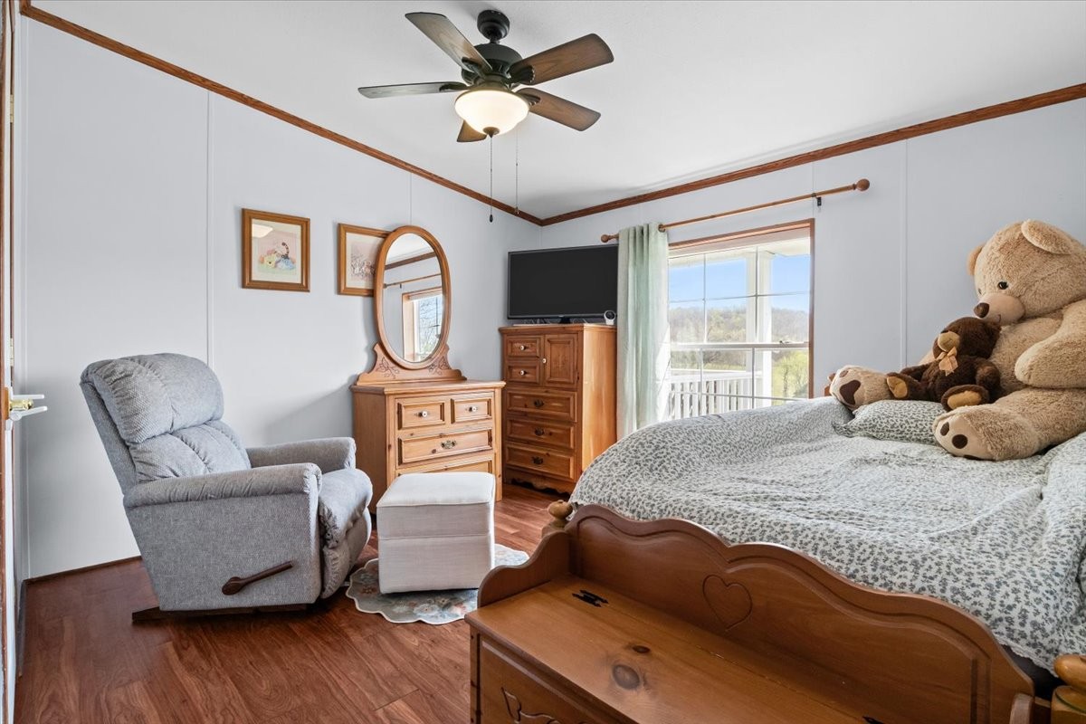 1644 West Blue Creek Road Waverly, TN 37185 - Photo 34 of 61 a bedroom with a bed a couch and dresser