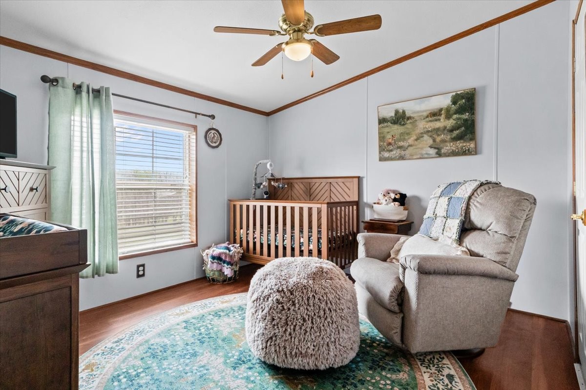 1644 West Blue Creek Road Waverly, TN 37185 - Photo 37 of 61 a bedroom with a bed and wooden floor