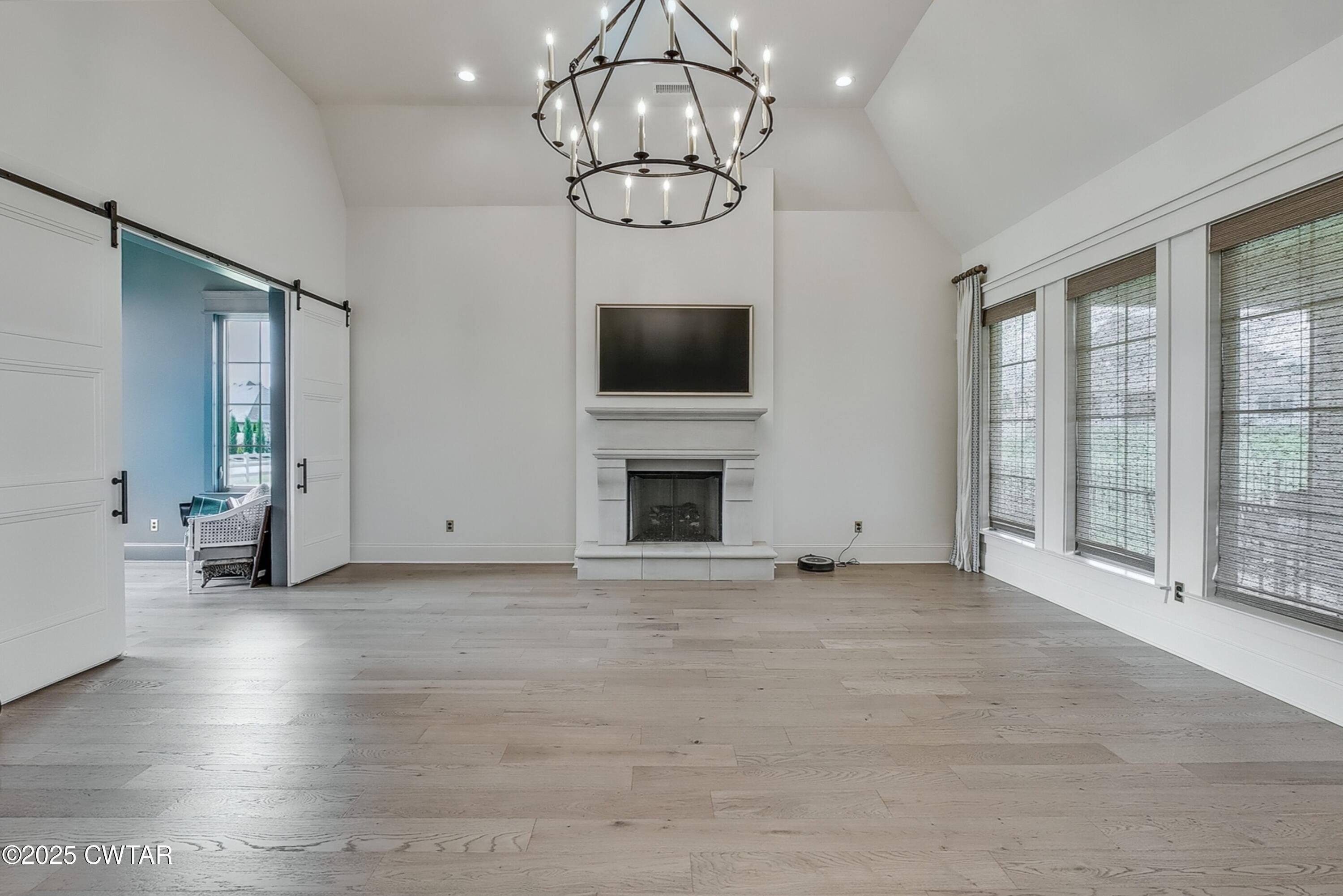 52 Buckingham Cove Jackson, TN 38305 - Photo 13 of 33 a view of an empty room with wooden floor and a window