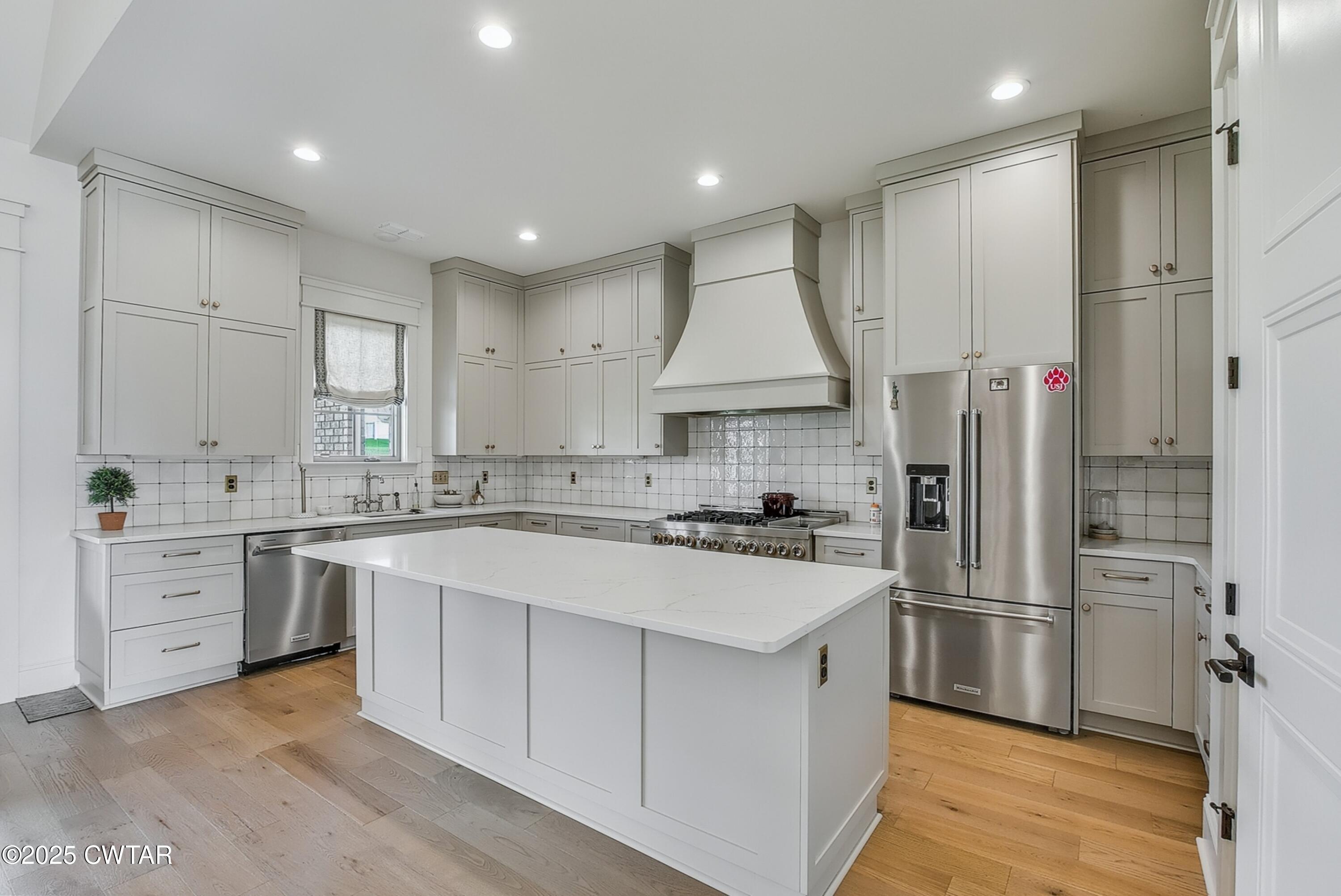 52 Buckingham Cove Jackson, TN 38305 - Photo 14 of 33 a kitchen with white cabinets and stainless steel appliances