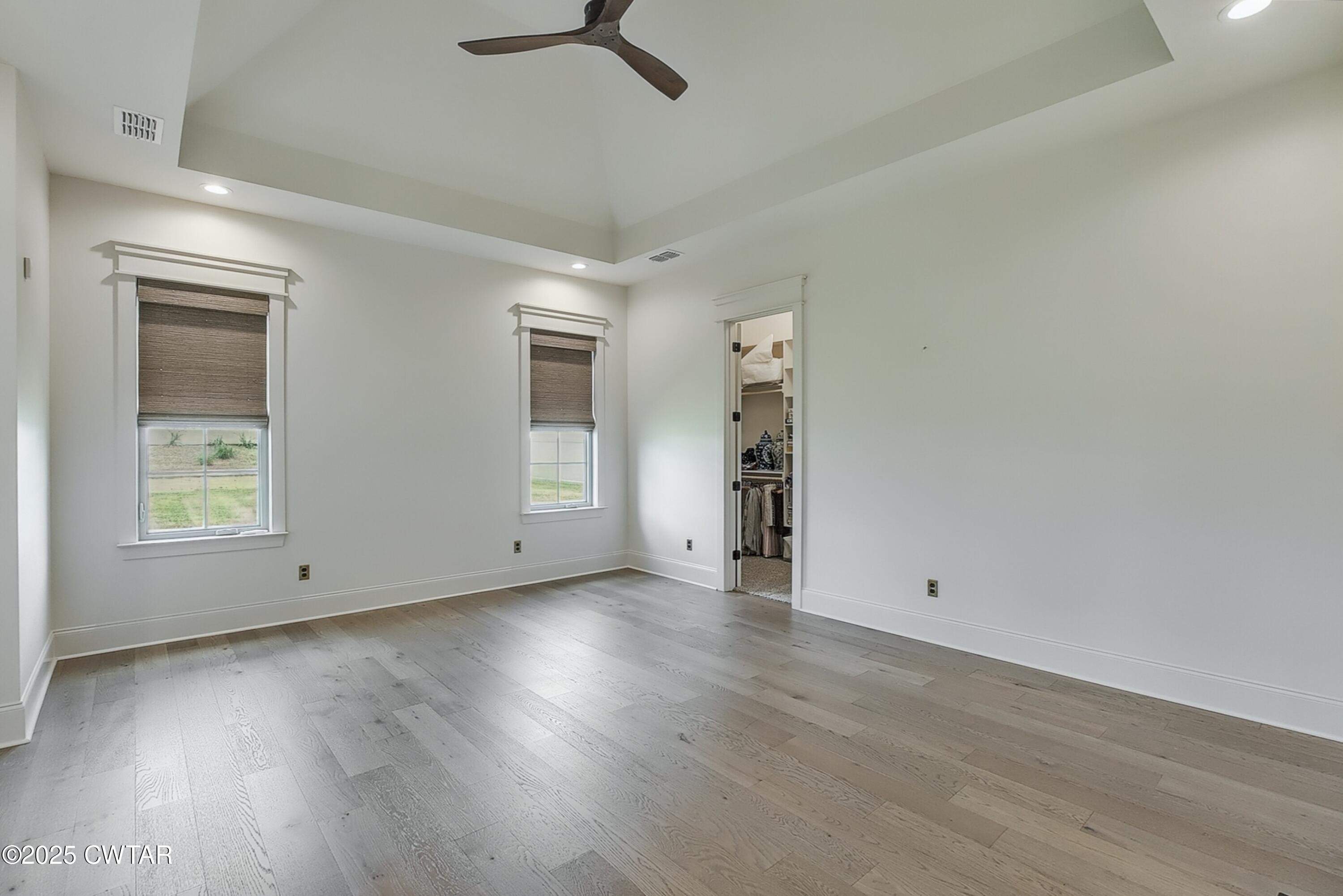 52 Buckingham Cove Jackson, TN 38305 - Photo 17 of 33 an empty room with wooden floor cabinet and windows