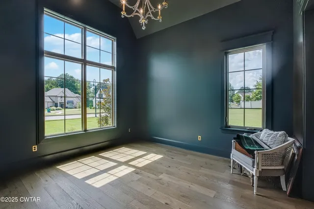 a view of a room with a window and lounge chair