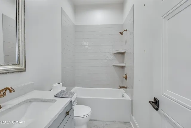 a bathroom with a sink toilet and bathtub