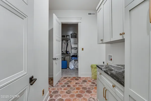 a kitchen with a refrigerator and a stove