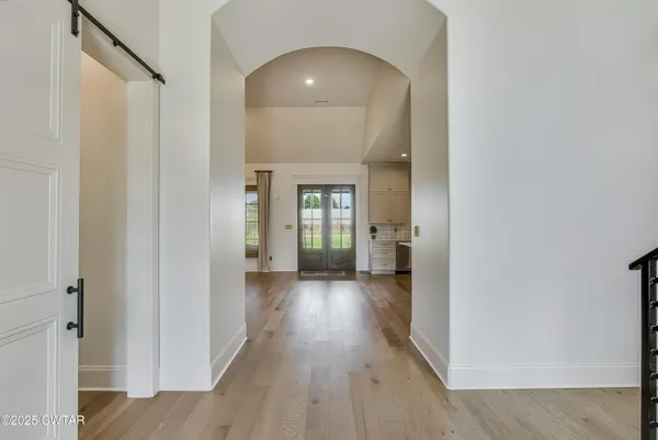 a view of a hallway with wooden floor