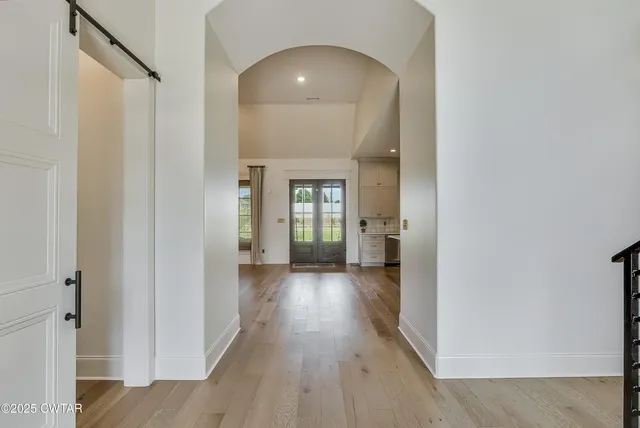 a view of a hallway with wooden floor