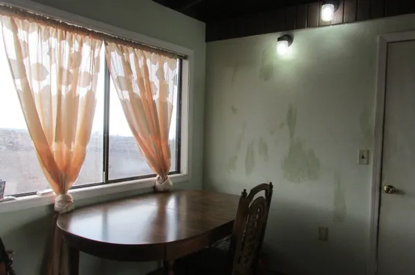 a view of a workspace with furniture and window