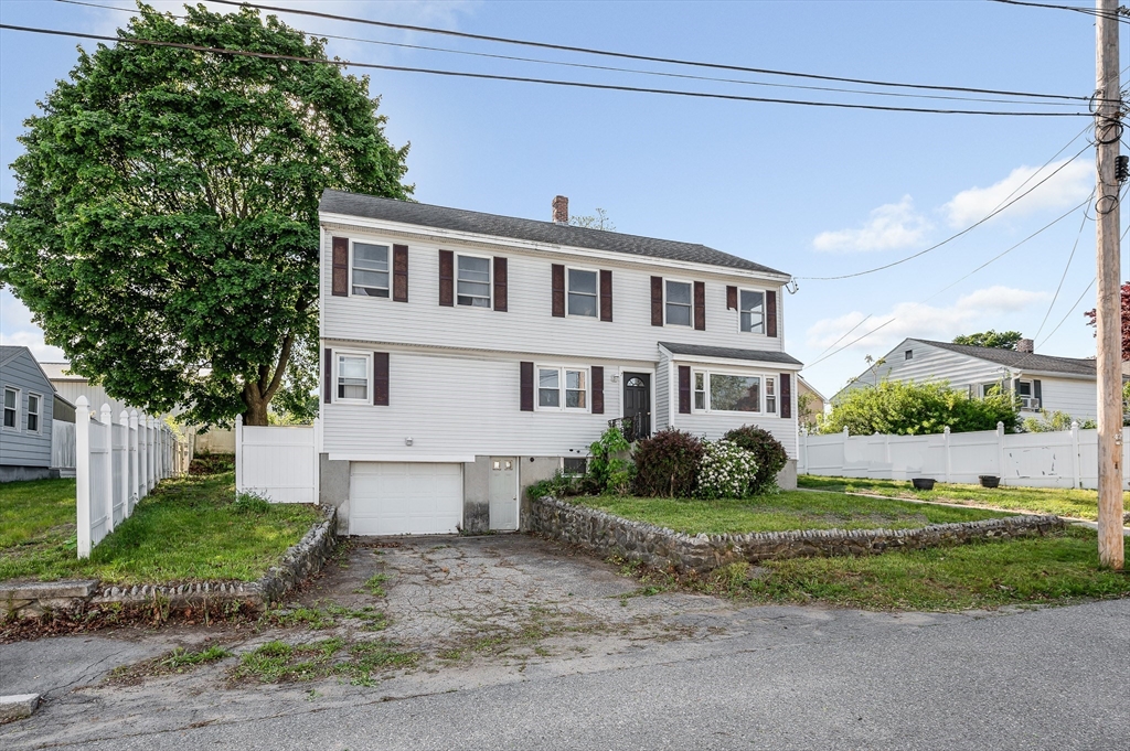 7 Marie Street Methuen, MA 01844 - Photo 2 of 39 a front view of a house with a yard and garage