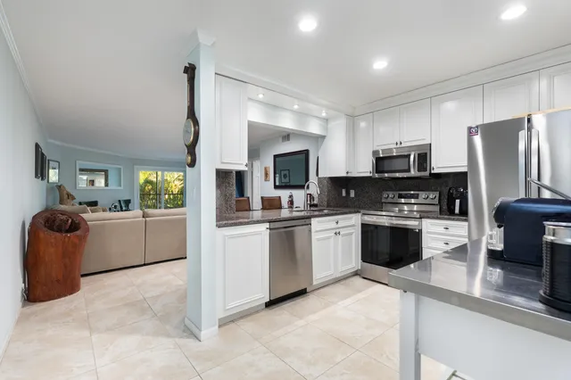a kitchen with a sink cabinets and stainless steel appliances
