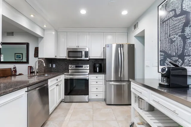 a kitchen with a refrigerator sink and microwave