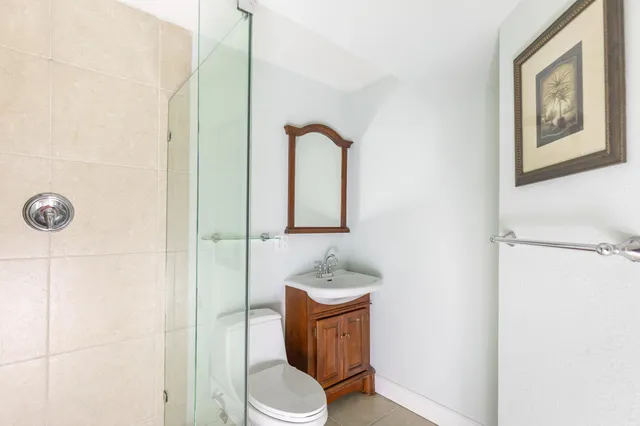 a bathroom with a toilet sink and mirror