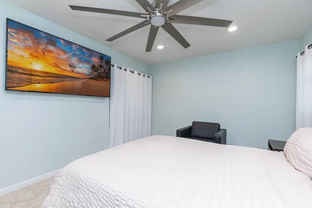 a bedroom with a bed and painting on the wall