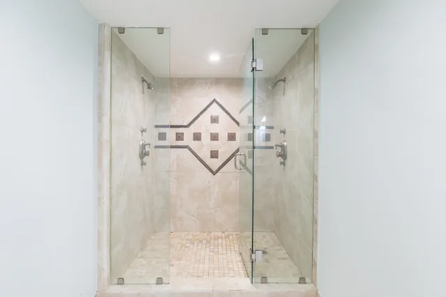 a bathroom with a glass shower door