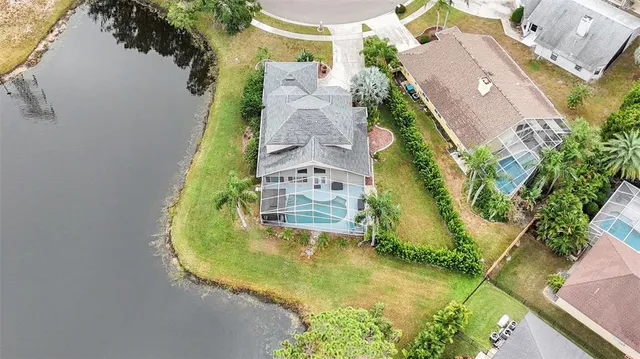 an aerial view of residential house with outdoor space and swimming pool