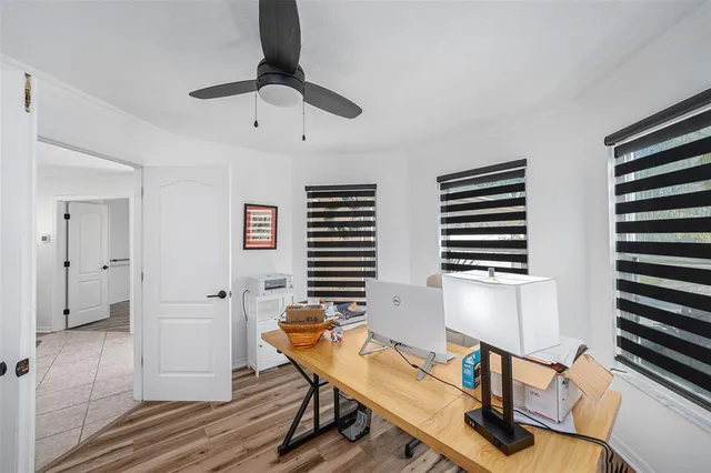 a view of a workspace with furniture and a window